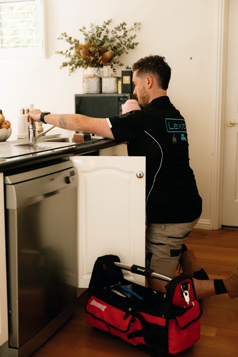 Tap testing with customer at the kitchen sink